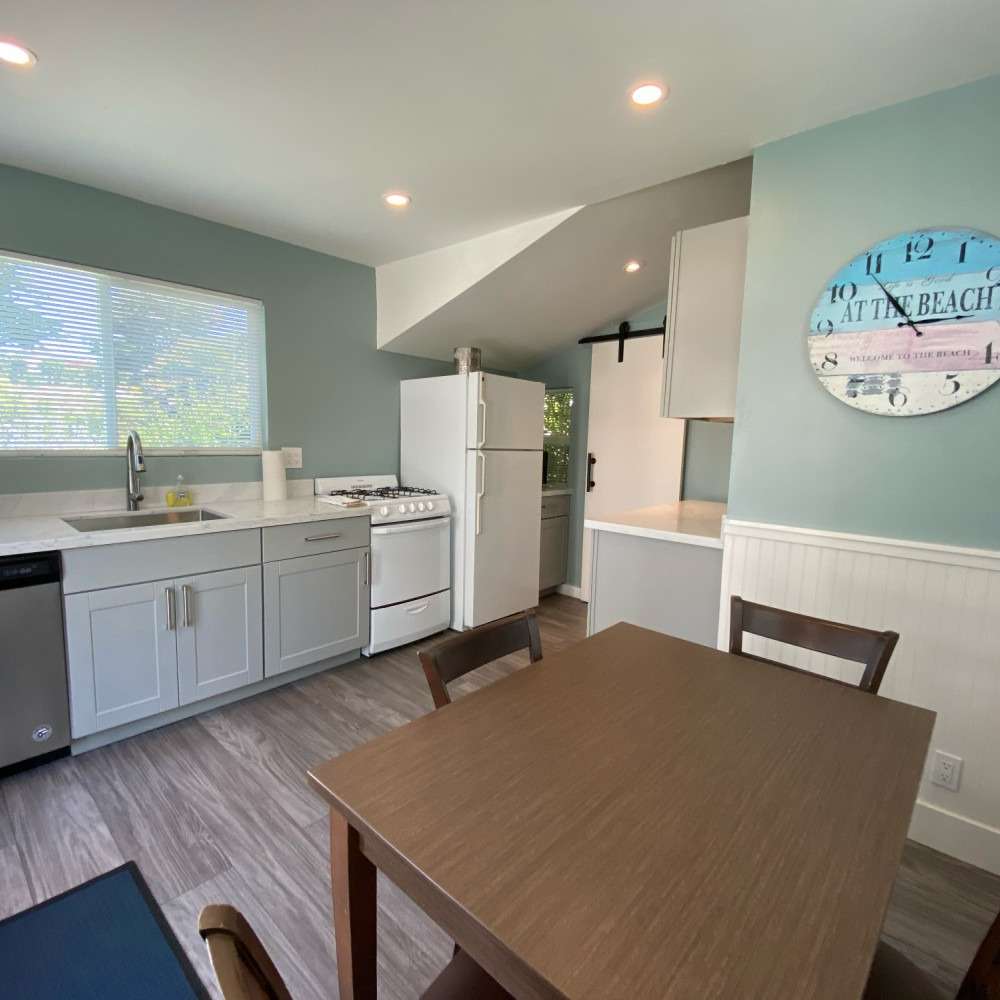 Full kitchen with dining table and four chairs